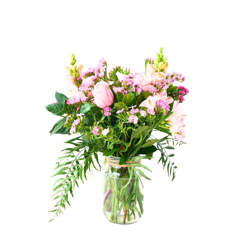 Jar arrangement of flowers in a clear vase on a white background