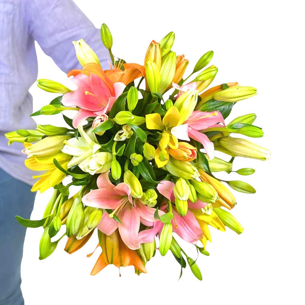 Close-up of Kiss Blush Lily Bouquet showing pastel lily petals, unopened buds and lush green foliage