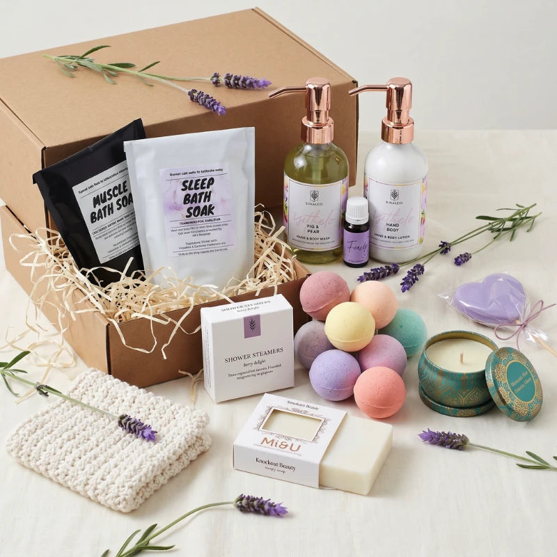 Lady of Leisure spa-at-home gift box with Dinaledi Fig and Pear hand and body duo, Muscle and Sleep Bath Soaks, Berry Delight Shower Steamers, Mi&U Knockout Beauty soap, pastel bath bombs, soy candle in a teal-and-gold tin and a crocheted washcloth, by Fabulous Flowers and Gifts