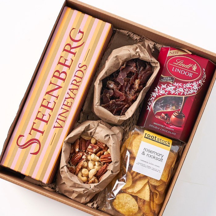 Luxury wine and snack hamper featuring Steenberg wine, gourmet treats, chocolate and artisan crisps.