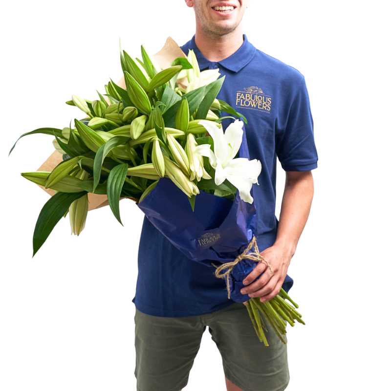 Lily Bouquet with white lilies and fresh greenery held by a person in a blue shirt