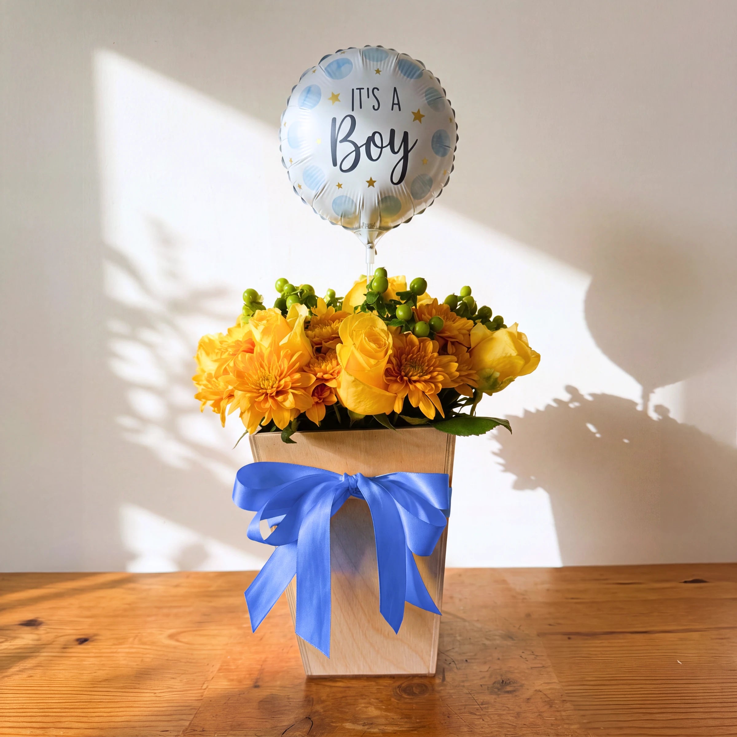 Little Prince It's a Boy flower box of yellow roses, chrysanthemums and green berries with a blue bow and balloon