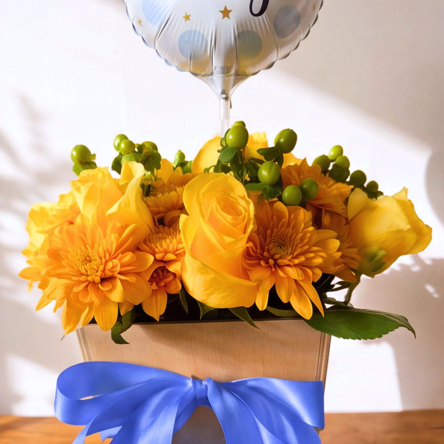 Close-up of the Little Prince yellow flower box and It's a Boy balloon for a new baby boy