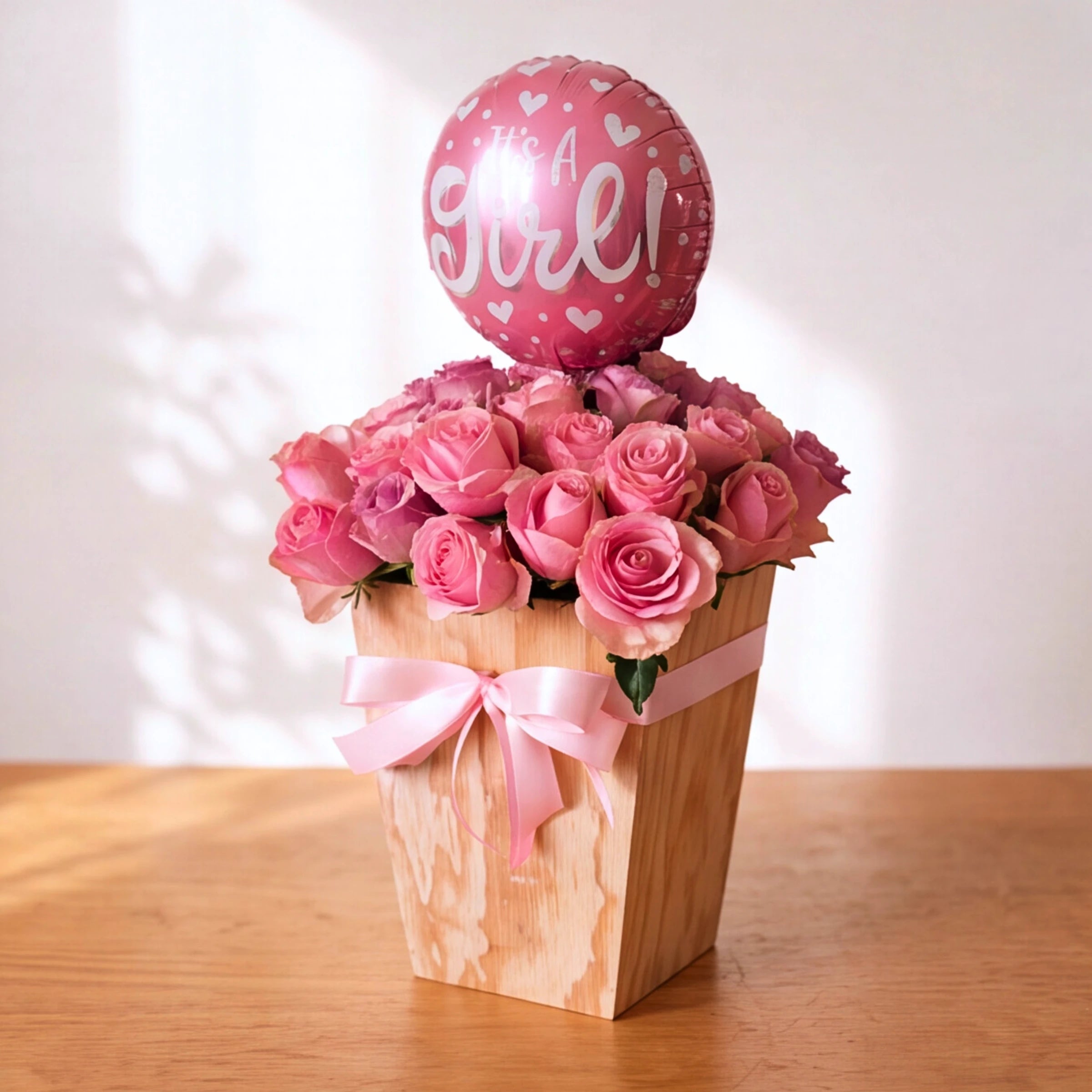 Little Sweetheart pink rose and lilac box arrangement with pink satin bow and It's a Girl foil balloon