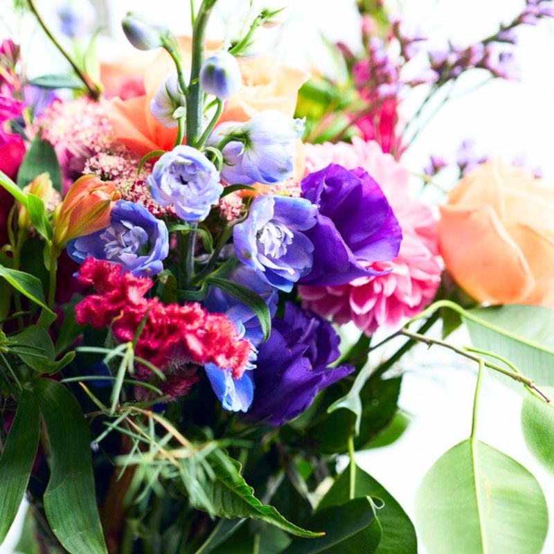 Jar flower arrangement of colorful flowers with a blurred background