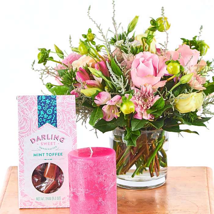 Love and Light Flower Gift Set arranged with fresh pink roses, gift candle and mint toffee for a curated care gesture