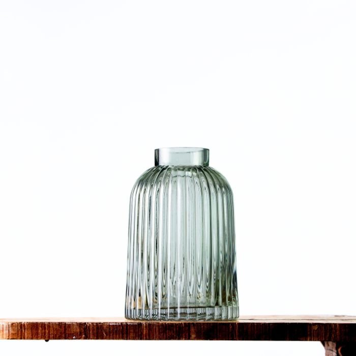 Contemporary Luminous Striped Vase featuring vertical ribbed patterns on clear glass, perfect for modern interiors."
