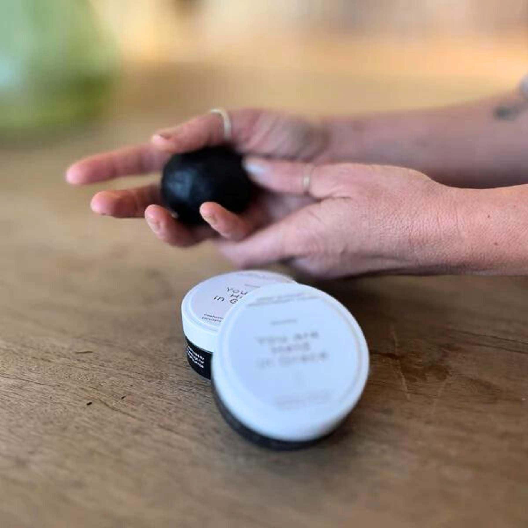 Hand holding MOHAU Aromatherapy stress relief dough, available at Fabulous Flowers and Gifts for holistic well-being.