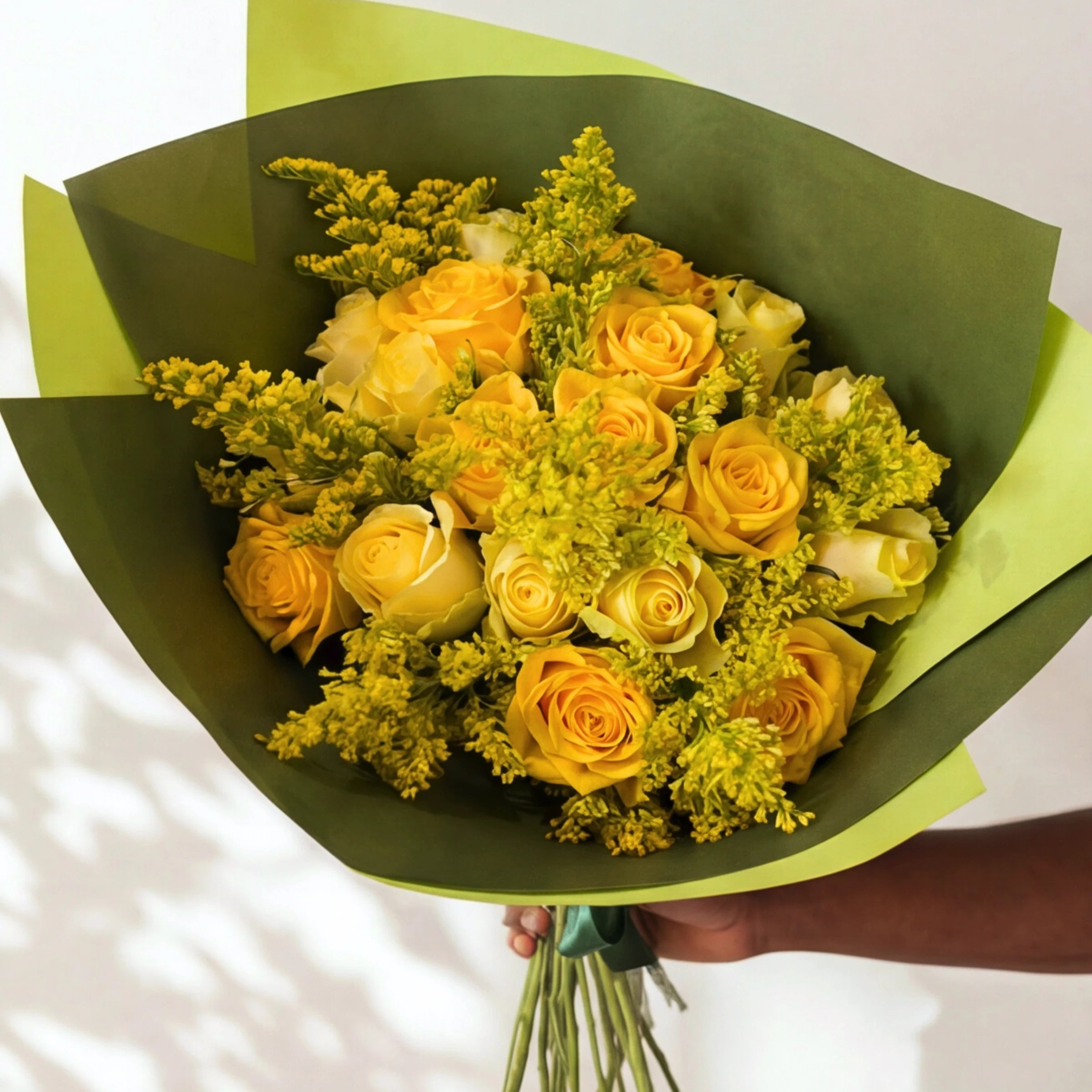 The Meadowlark yellow flower bouquet, yellow roses and solidago wrapped in green