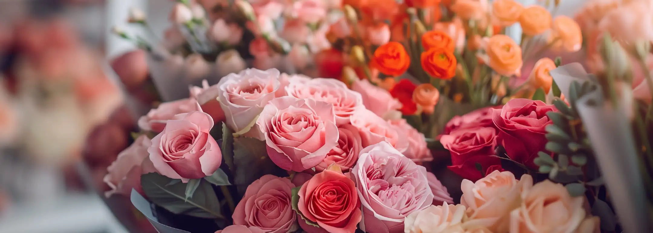 Background of colourful flowers with text overlay describing Josie van Aswegen and Nicholas James's leadership at Fabulous Flowers, emphasising the blend of tradition and innovation in creating unique floral experiences. MEET THE TEAM at Fabulous Flowers and Gifts.