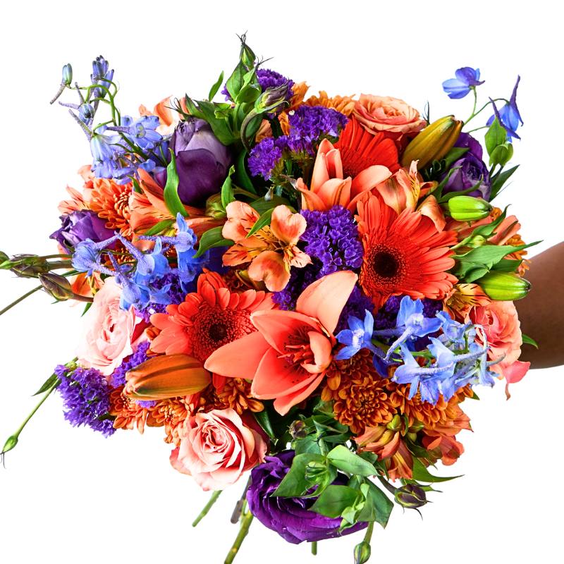 Colourful mixed flower bouquet — orange lilies and gerberas with lilac roses, purple statice and bright blue accents