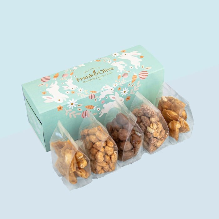 Nuts and Brittles Treat Box - Fabulous Flowers & Gifts pastel gift box with four assorted nutty snacks and crunchy peanut brittle.
