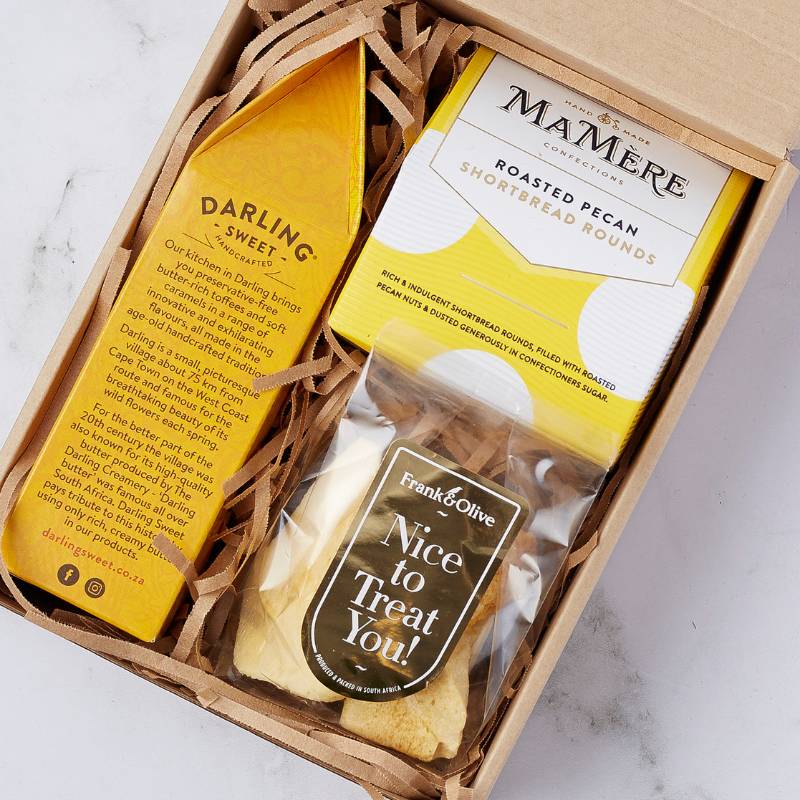 Close-up of the Pecan Shortbread & Treats Box showcasing hand-crafted Darling Sweet toffees, MaMère roasted pecan shortbread rounds, and Frank & Olive 'Nice to Treat You!' biscuits.