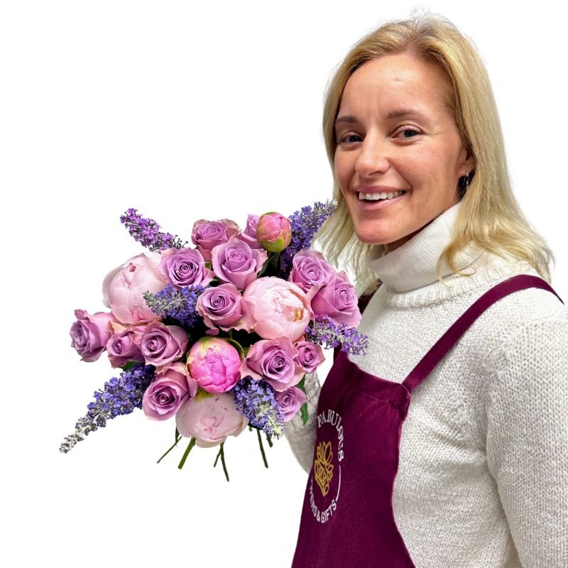 Florist holding Peonies at Dusk bouquet of lilac roses, pink peonies and lavender – Fabulous Flowers and Gifts.