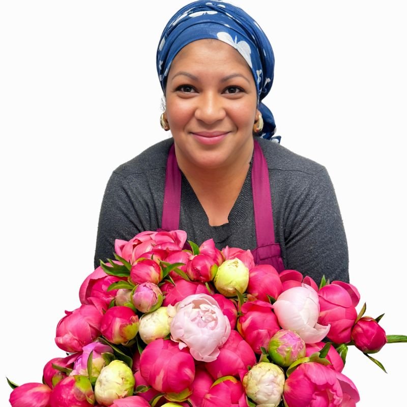 Smiling team member with the Peony Parade - Fabulous Flowers and Gifts bouquet bursting with colourful peonies.