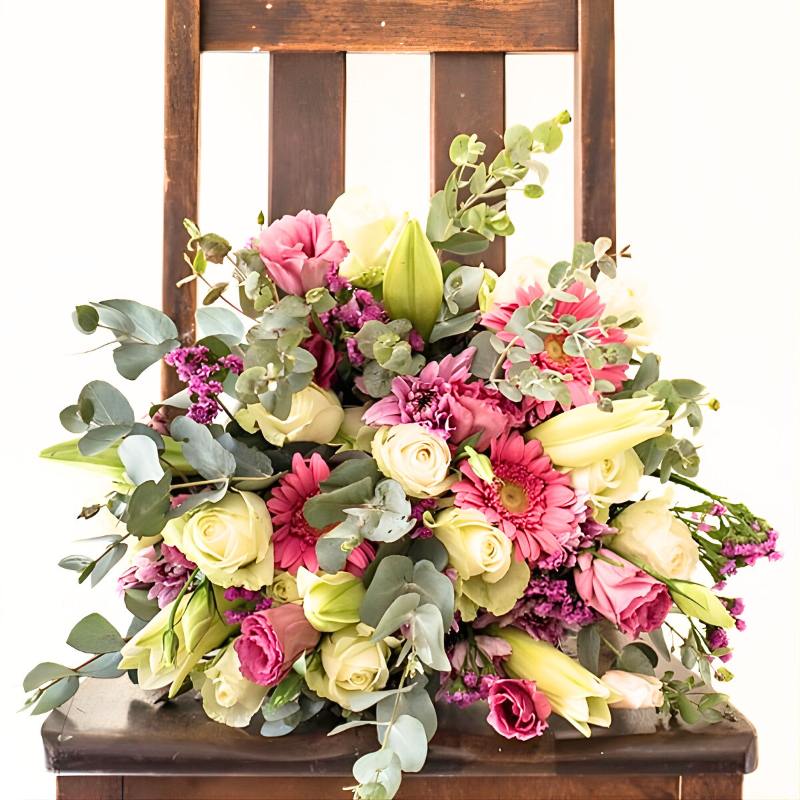 Bouquet of flowers on a wooden chair with a white background
