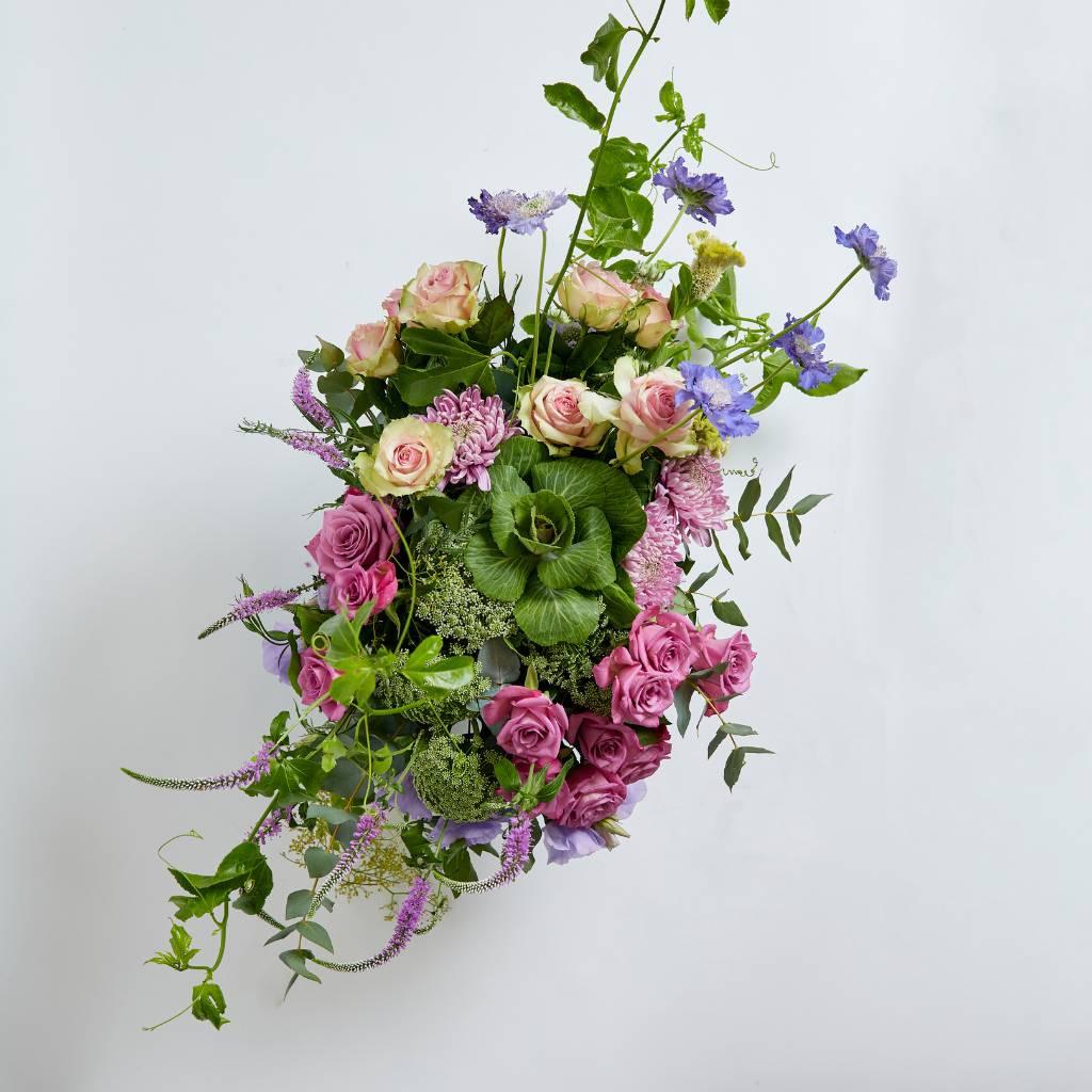 Modern flower arrangement in glass vase with pink roses, scabiosa, lisianthus, veronica and granadilla vines - Fabulous Flowers