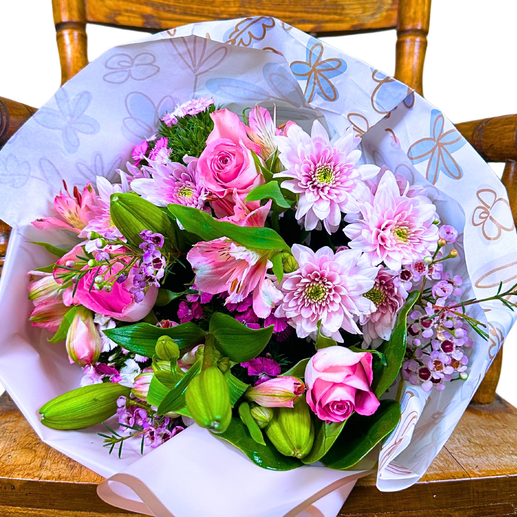 Bouquet of pink and green flowers on a wooden chair