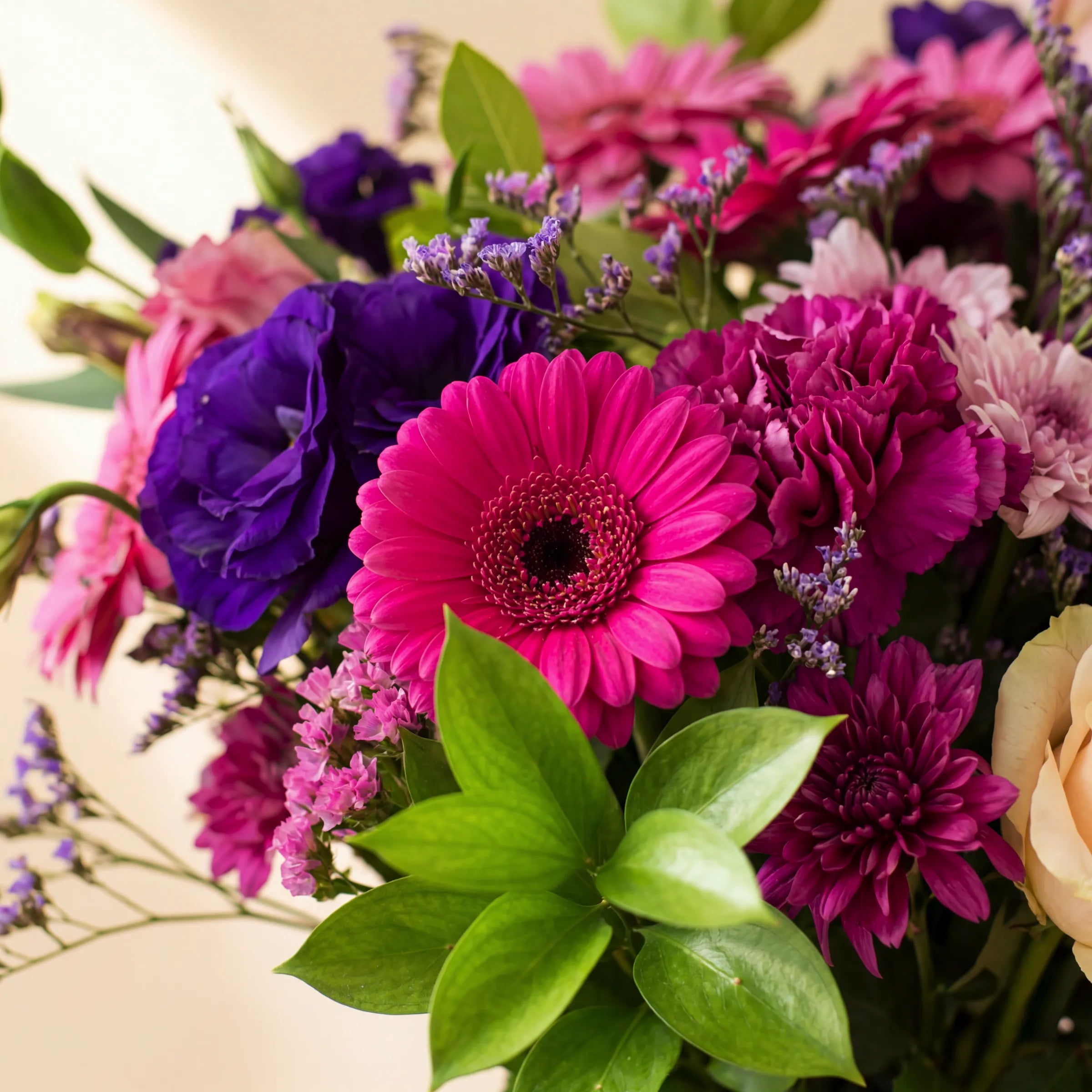 Pretty in Pink and Purple close-up with hot pink gerbera, magenta carnations, purple lisianthus and pink statice