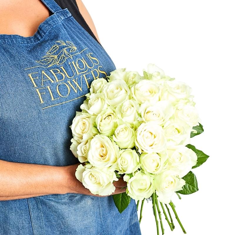 Florist holding the Pure Snow bouquet of 24 white roses