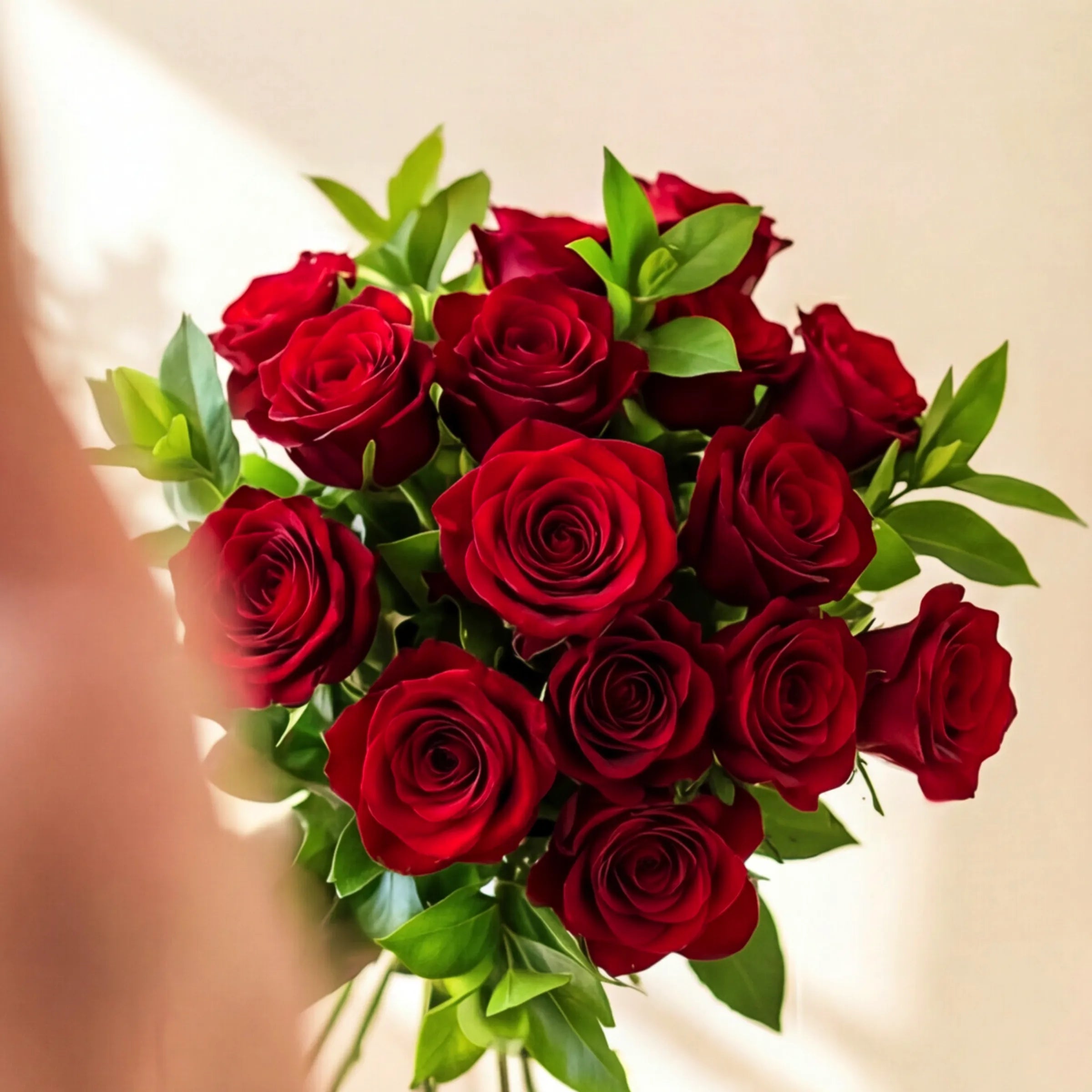 Two dozen red roses with green foliage in the Red Rose Greenery Bouquet, hand-tied by Fabulous Flowers since 1999