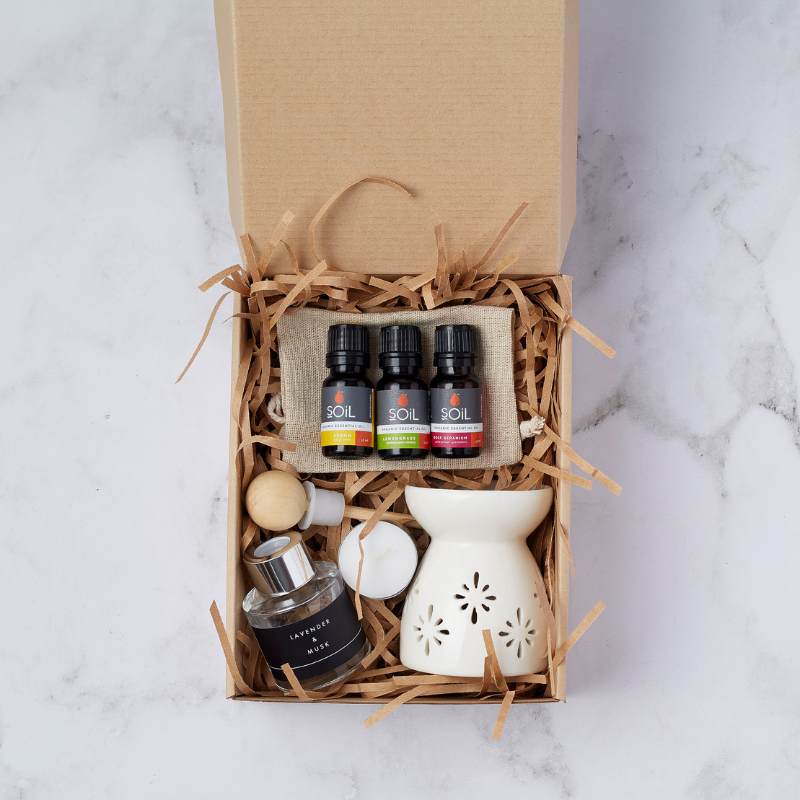 Rose Garden Indulgence Set with organic essential oils, a ceramic oil burner, lavender and musk diffuser, and a tea light candle.