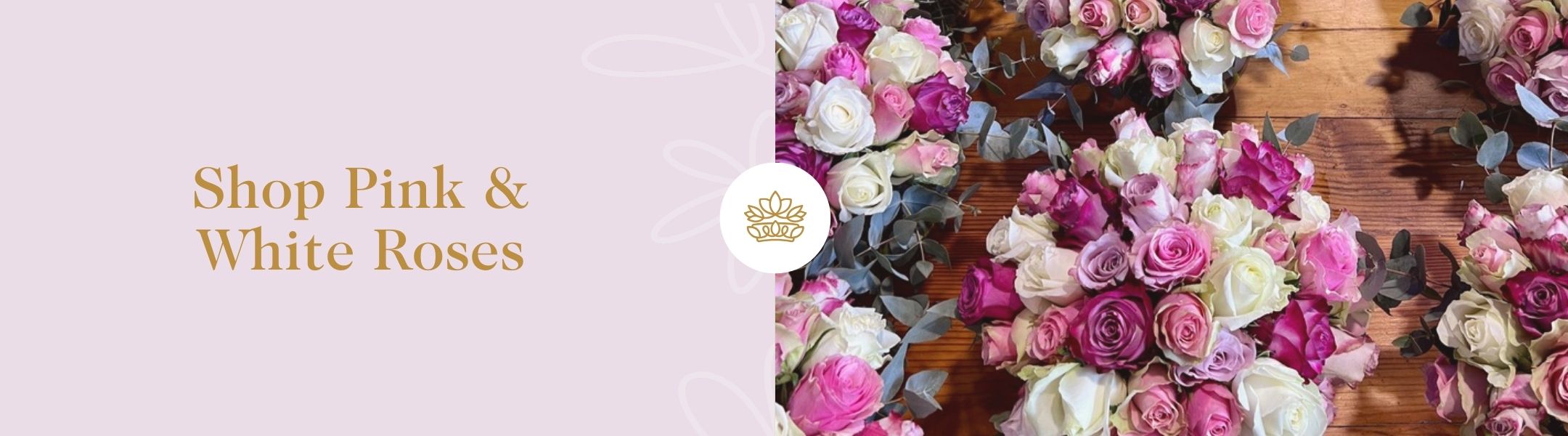 Multiple bouquets of pink and white roses with eucalyptus on wooden surface beside “Shop Pink & White Roses” – Fabulous Flowers & Gifts.