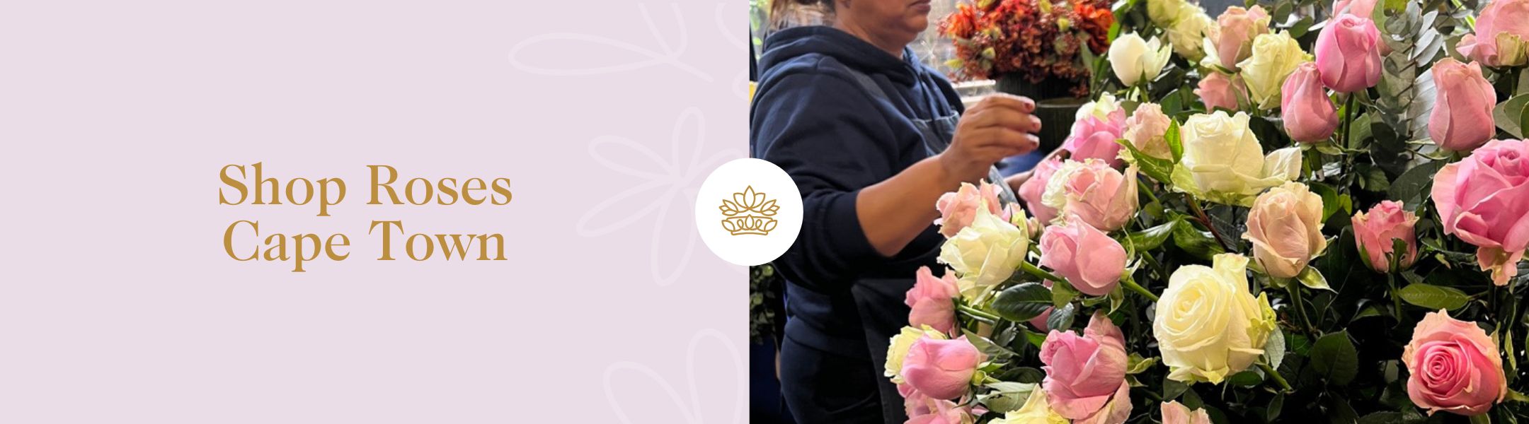 Shop Roses Cape Town - Fabulous Flowers and Gifts with florist arranging a display of soft pink and cream roses in Cape Town studio.