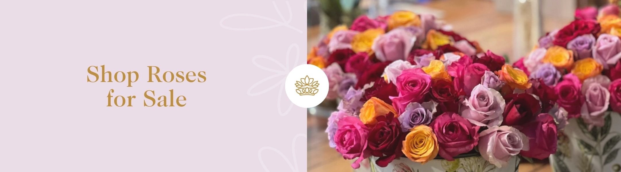 Shop Roses for Sale - Fabulous Flowers and Gifts featuring bright mixed rose bouquets in floral vases on a wooden surface indoors.