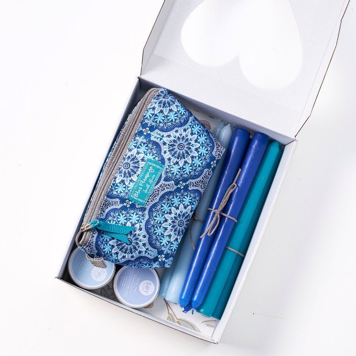 Soft Light & Gentle Things - Fabulous Flowers & Gifts top-down view of wellness gift with blue candles and self-care pouch.