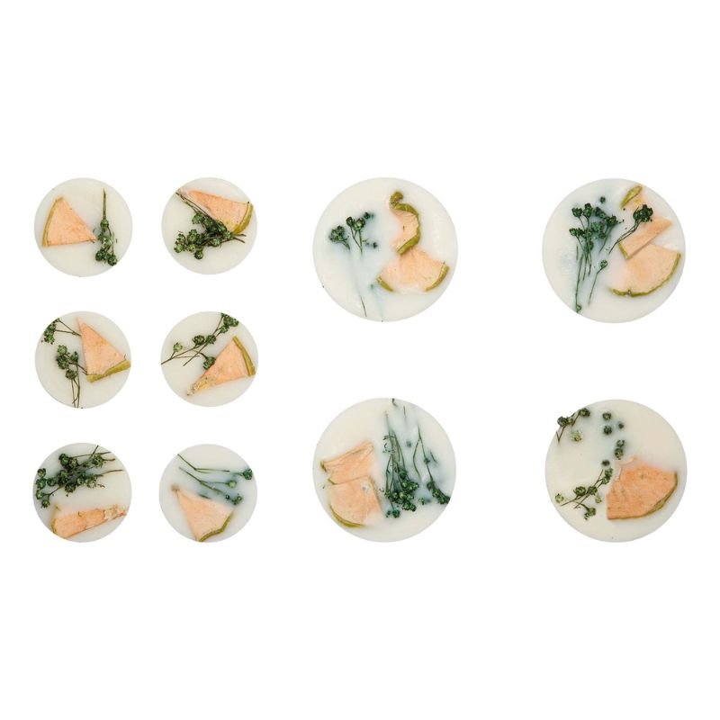Set of small round candies with peach and green leaf design on a white background