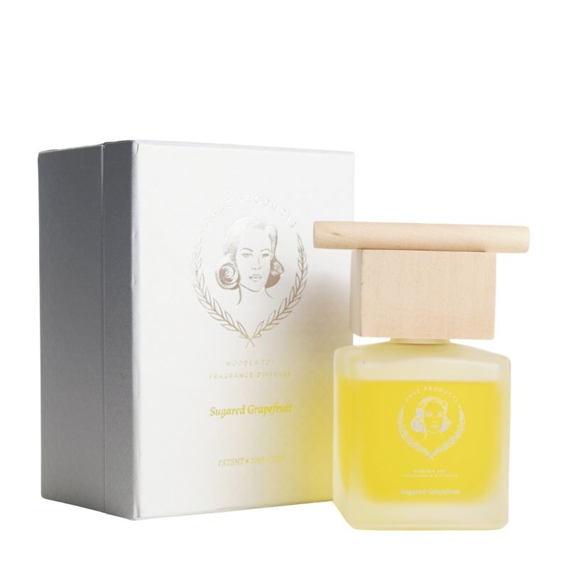 Yellow perfume bottle with wooden cap and white box on a white background