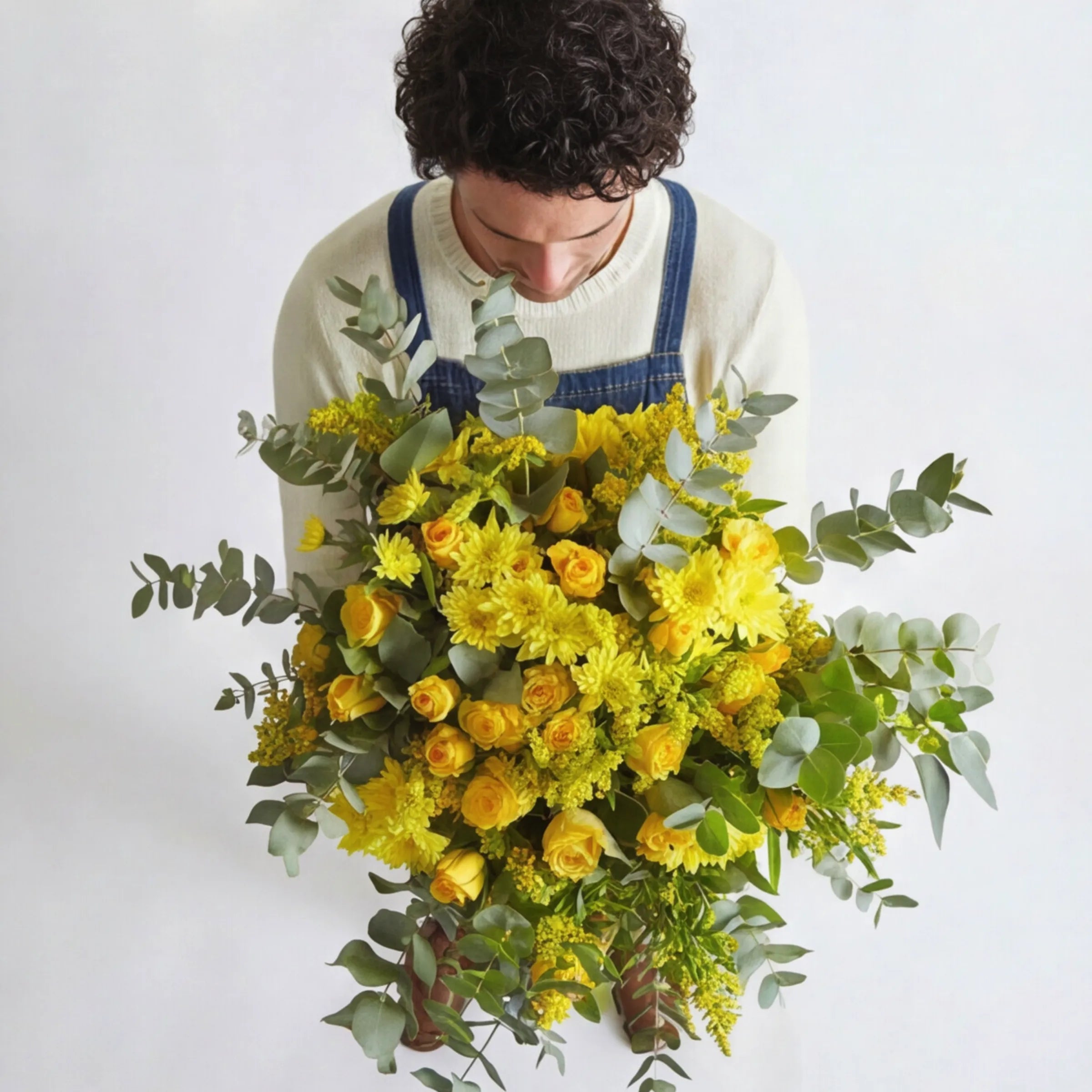 Top-down view of Sunkissed Yellow Bouquet showing yellow roses, yellow spider chrysanthemums, yellow solidago clusters and silver-green eucalyptus hand-tied in a generous garden-style arrangement, locally grown by Fabulous Flowers South Africa