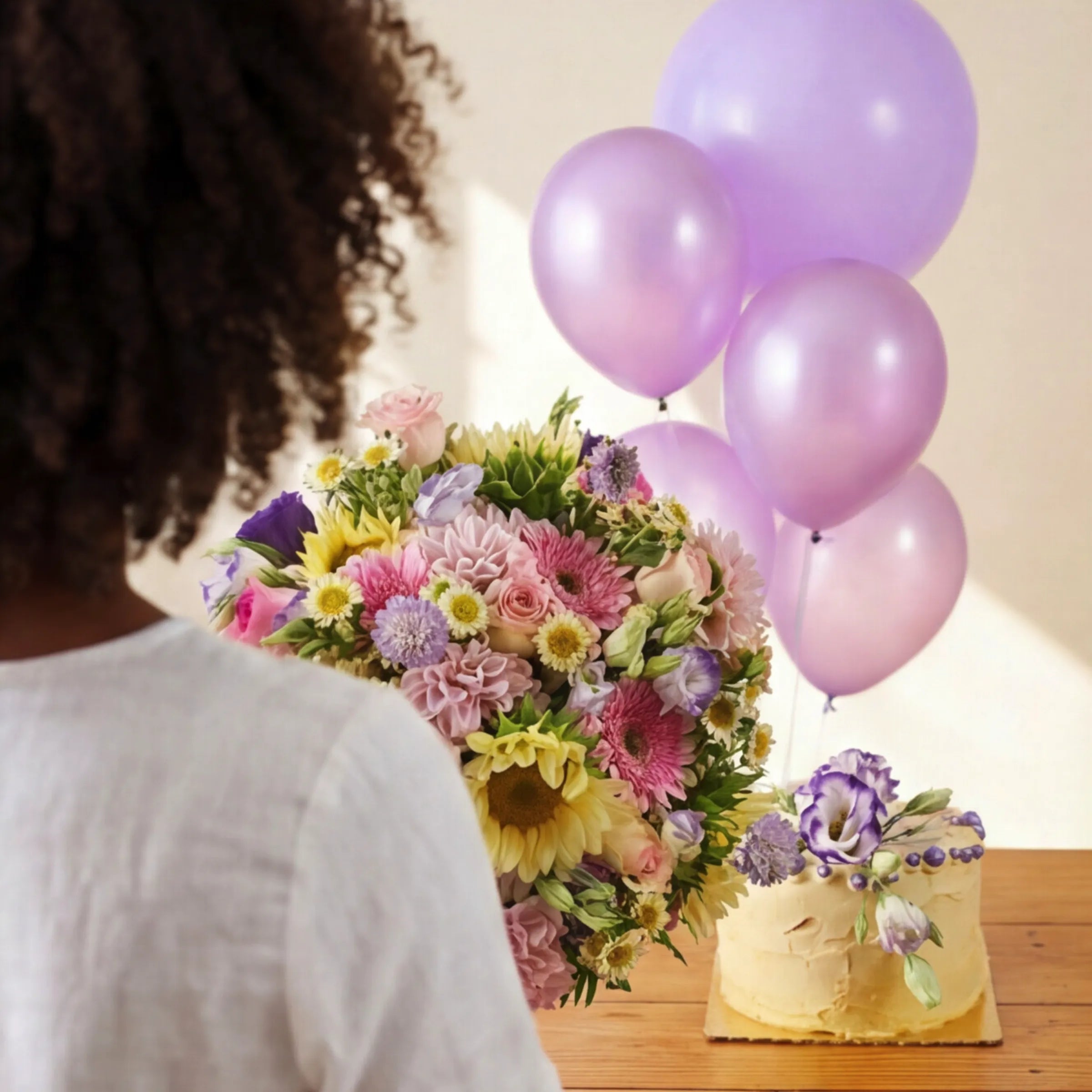 Sweet Celebration trio of bouquet, lilac balloons and floral cake styled for a Cape Town milestone birthday