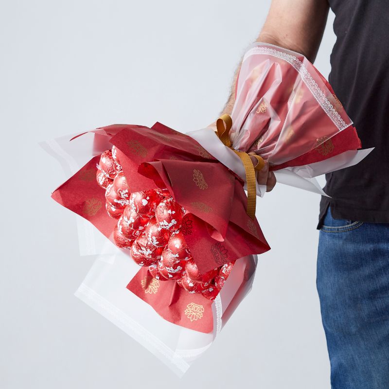 30 Sweetie Pie Delight Bouquet with red-wrapped Sweetie Pie chocolates arranged as a unique gift.