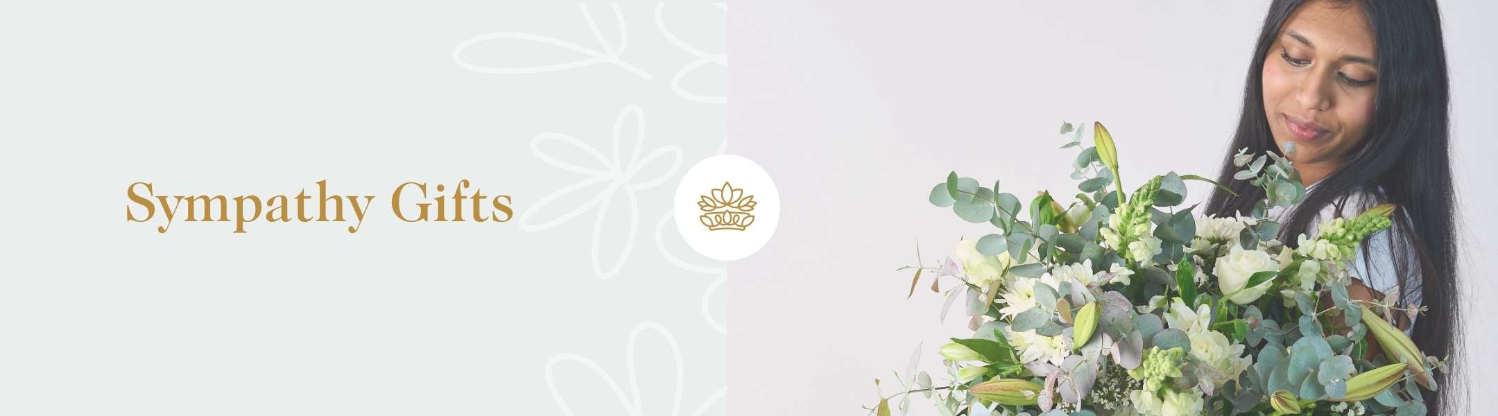 Sympathy Gifts by Fabulous Flowers and Gifts with a woman holding a delicate, green and white floral arrangement for condolences.