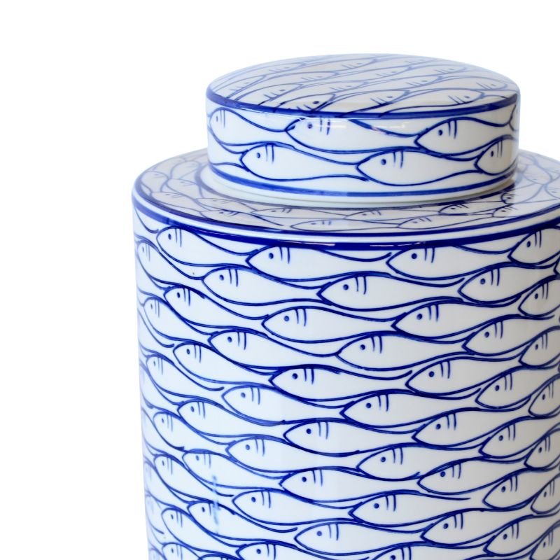 Ceramic jar with blue fish pattern on a white background