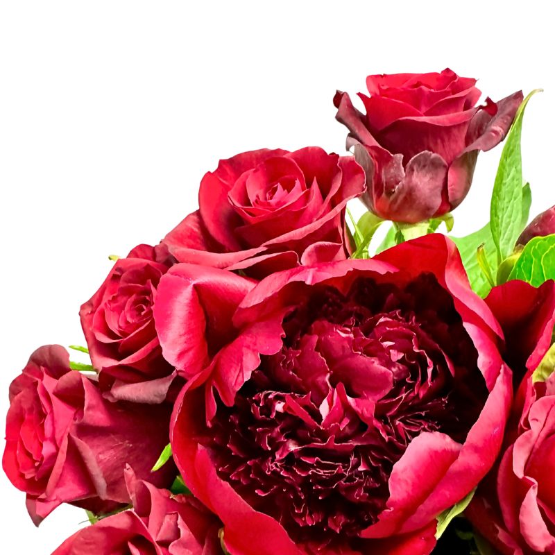 Deep red peony and red roses in The Bloom Between Us bouquet in full bloom from Fabulous Flowers and Gifts.