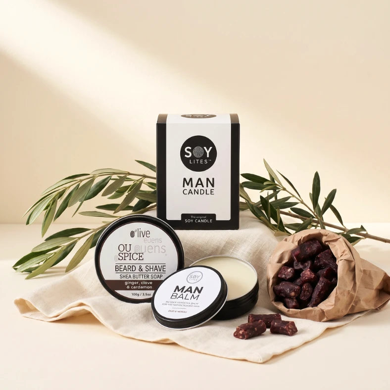 Essentials gift box for men flat-lay with Soy Lites Man Candle, Oud and Neroli Man Balm, OU Spice beard soap and droëwors, Fabulous Flowers and Gifts