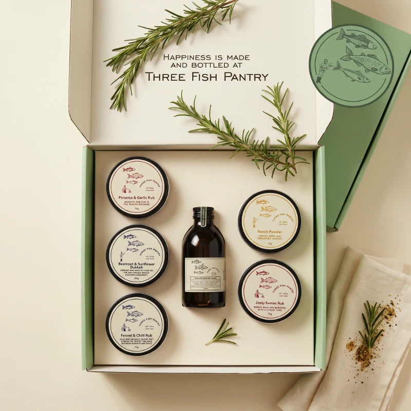The Fish Pantry Home Cook styled with the mint-green Three Fish Pantry gift box, five rubs and Worcestershire sauce, Fabulous Flowers and Gifts