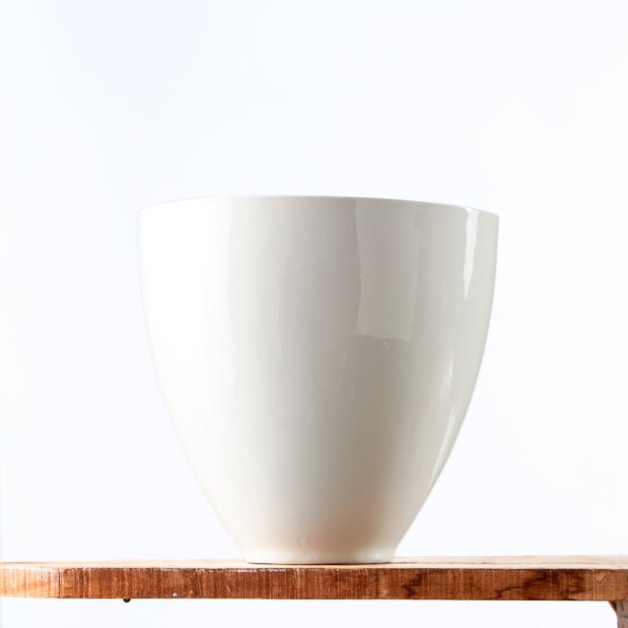 Tranquil Snow Vase featuring a minimalist white ceramic design with a smooth, glossy finish, ideal for modern interiors.