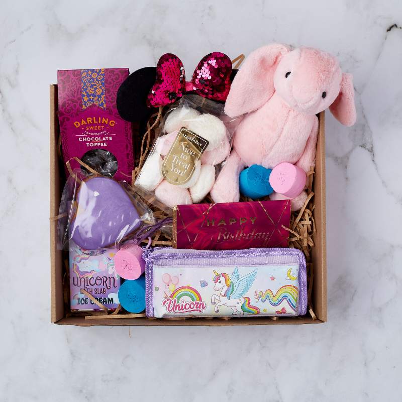 Unicorn Dreams Gift Box filled with soft plush bunny, unicorn-themed items, and sweet treats, perfect for a magical birthday.