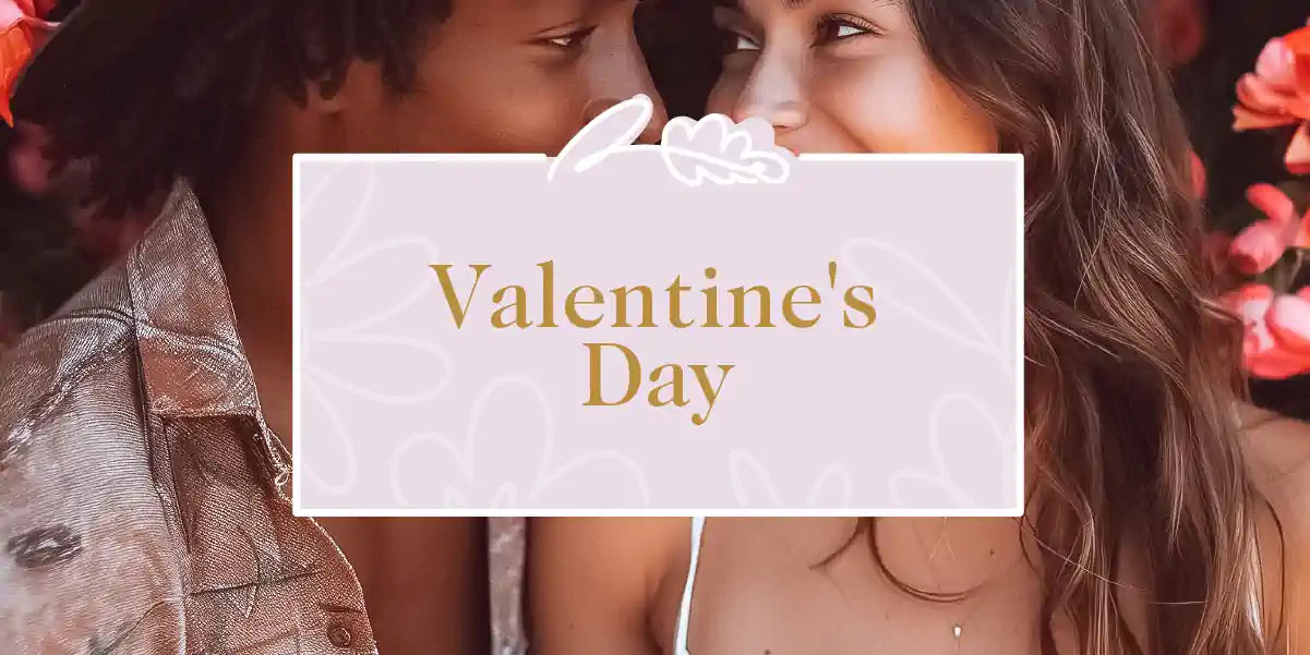 A romantic couple gazing at each other with flowers in the background. Fabulous Flowers and Gifts - Valentine's Day