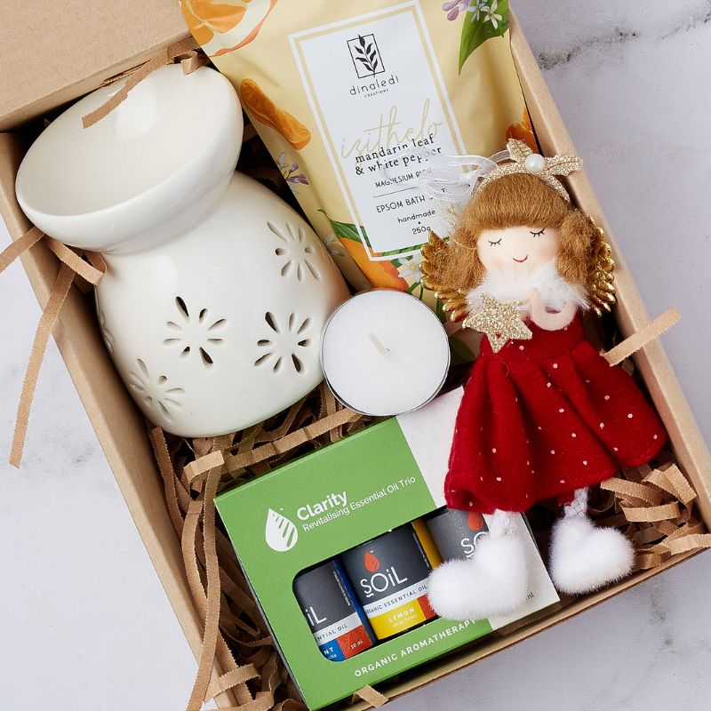Warm Wishes Care Gift Box with ceramic oil burner, essential oils, bath salts, tea light candle, and angel plush toy.