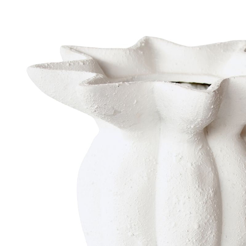 Close-up of a textured white vase on a light gray background