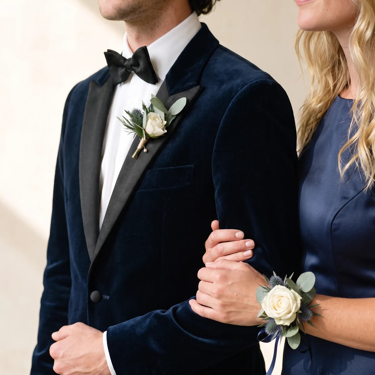 Couple in navy velvet and a navy dress wearing a matching thistle boutonniere and corsage, Fabulous Flowers South Africa