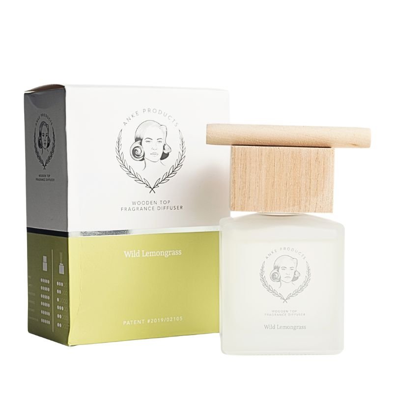 White wooden-top fragrance diffuser with packaging on a white background