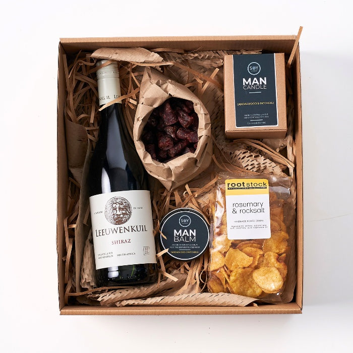 Yours Truly Hamper For Him featuring Leeuwenkuil Shiraz, Man Balm, Rosemary & Rocksalt crisps, and more in a craft box.