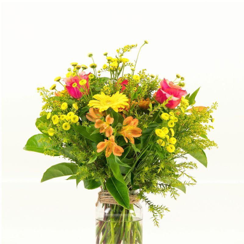 Close up of bright flower arrangement in jar container