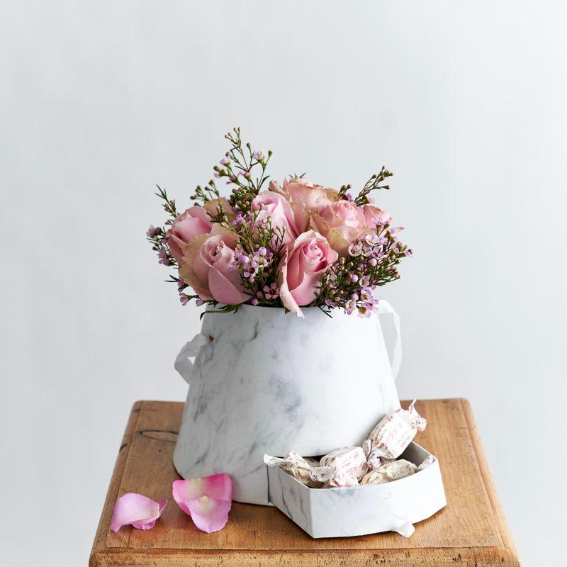 Love In A Gift Box arranged with light pink roses, wax flower and delicious nougat - Fabulous Flowers